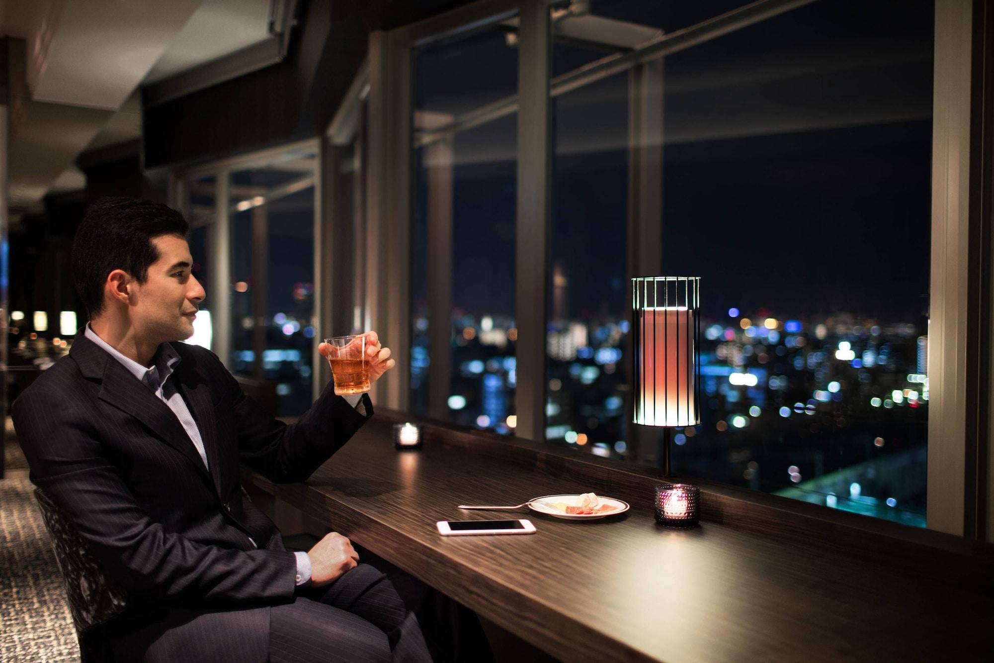 Courtyard By Marriott Shin-Osaka Station Hotel Exterior photo A man drinking at a bar